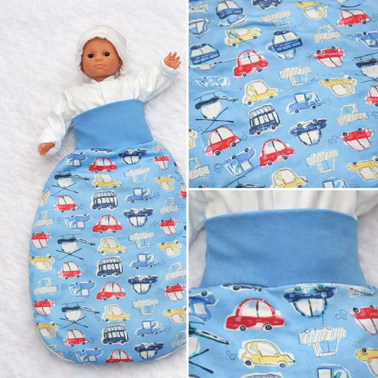 Detailaufnahme des hellblauen Babyschlafsacks aus Baumwolle mit Automuster und farbigen Fahrzeugmotiven