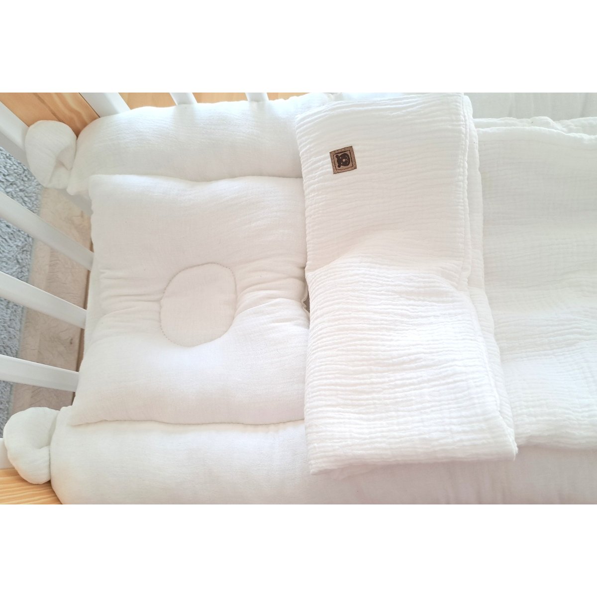 Stilvolles und sicheres Babybett Zubehör – ergonomisches Kissen und Musselin Decke